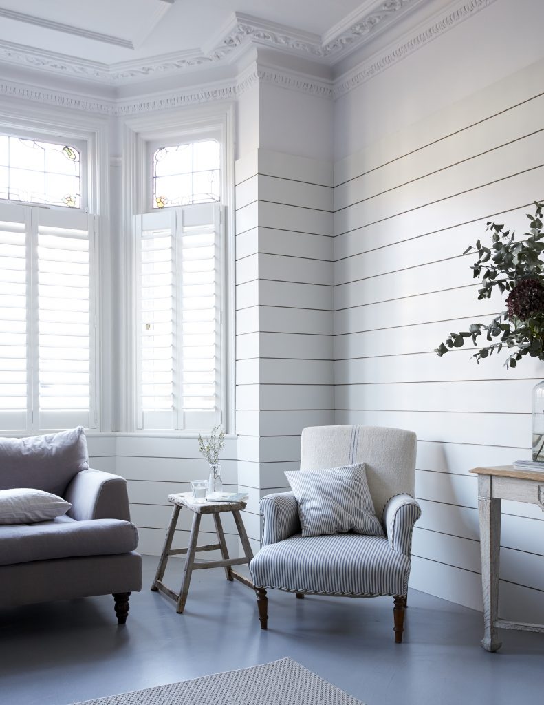 a living room filled with furniture and a large window