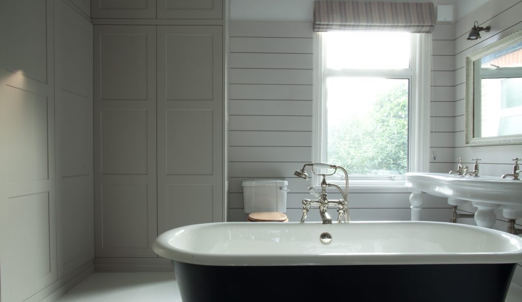 a sink and a white tub sitting next to a window