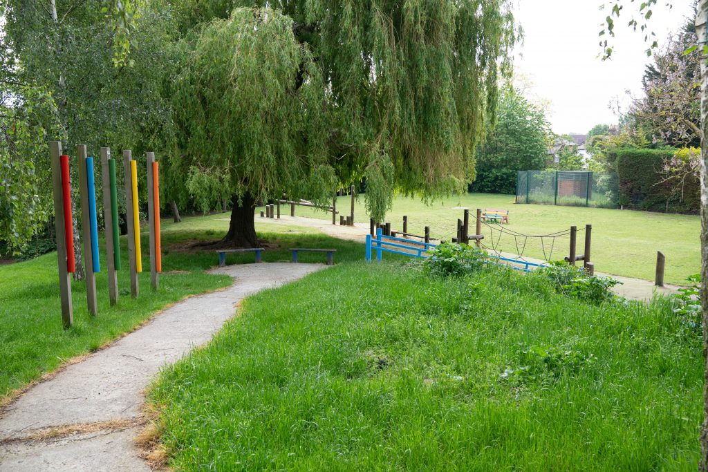a park bench in front of a tree