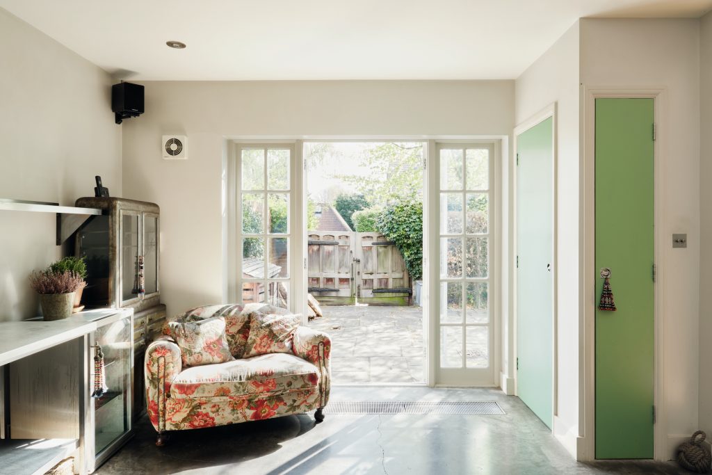 a living room filled with furniture and a large window