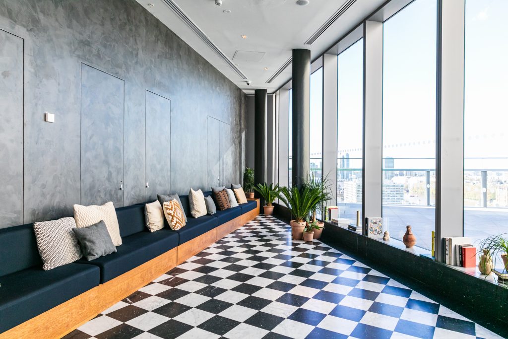 a room filled with furniture and a large window