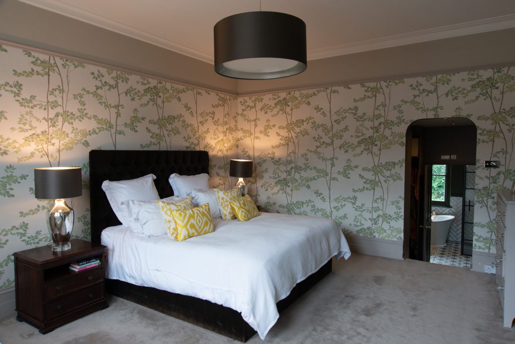 a bedroom with a bed and desk in a room