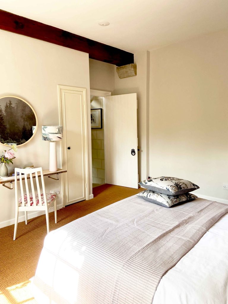 a bedroom with a bed and a mirror