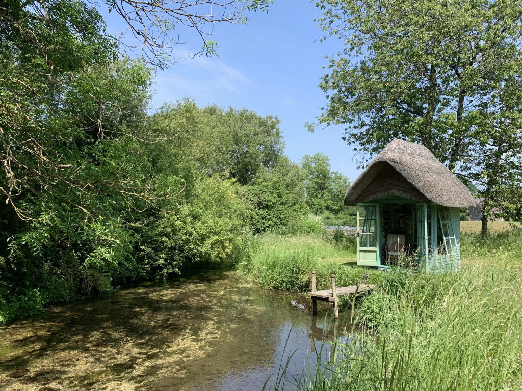 a small house surrounded by water
