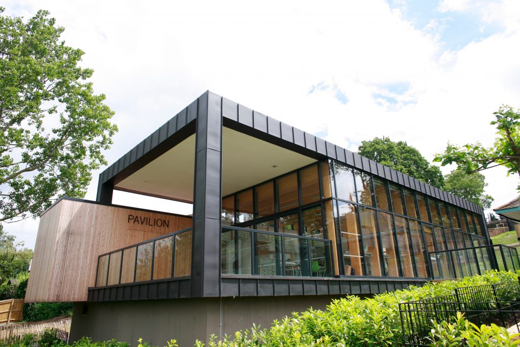 a large brick building with a wooden fence