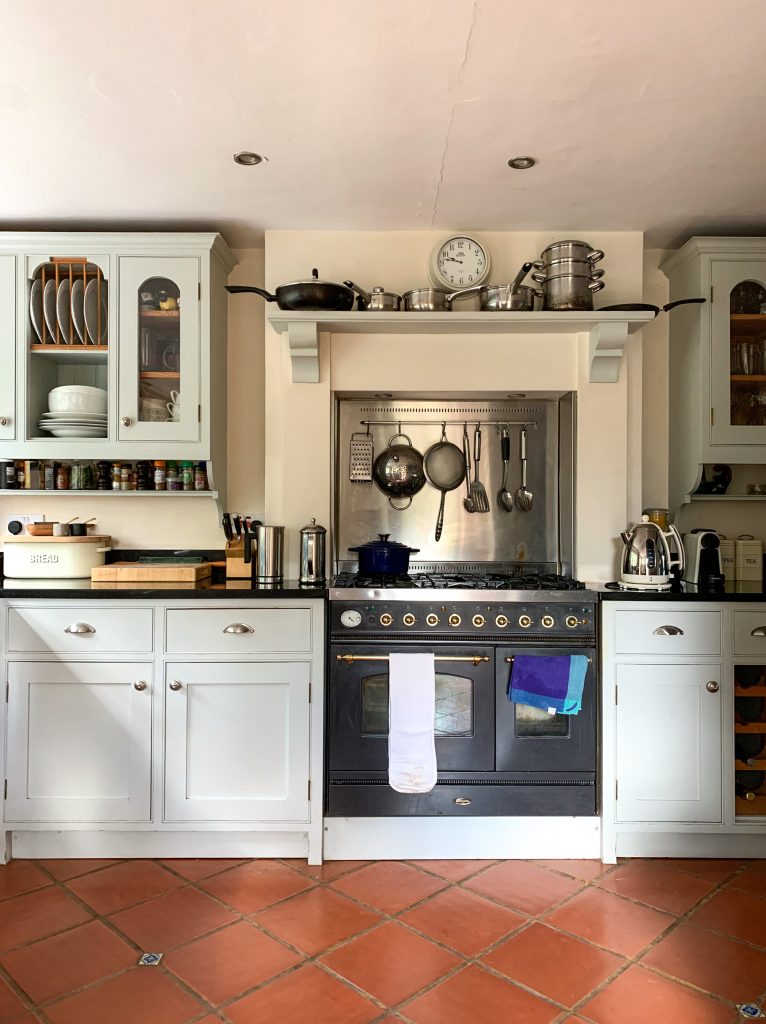 a stove top oven sitting inside of a kitchen