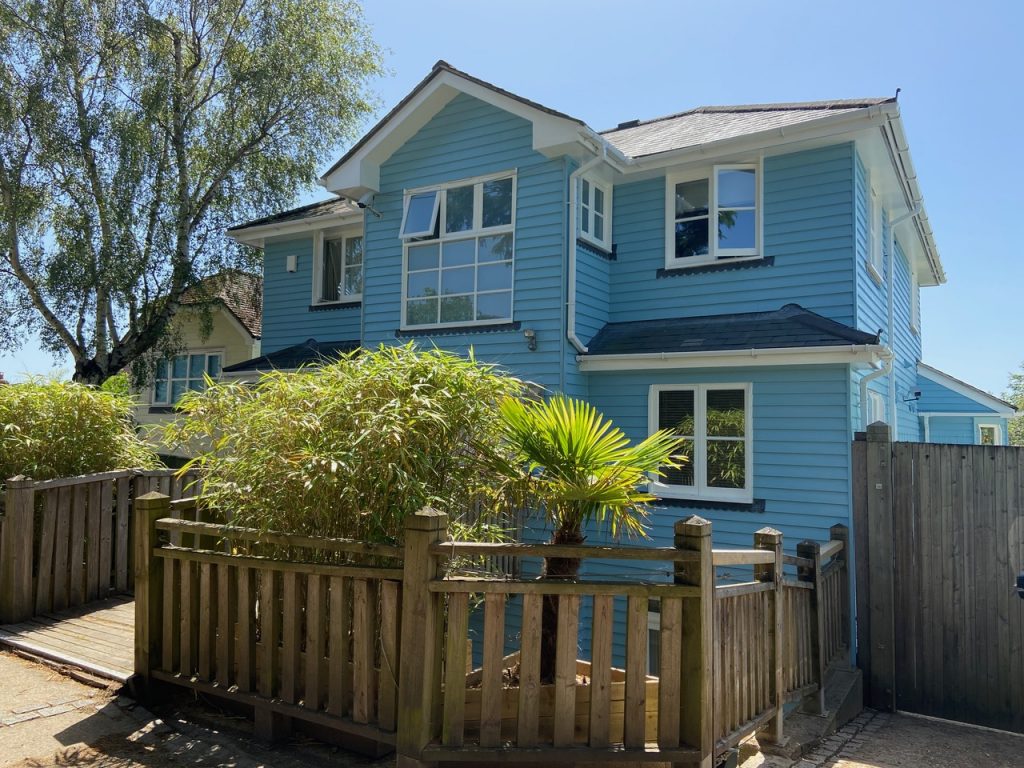 a house with a fence in front of a building