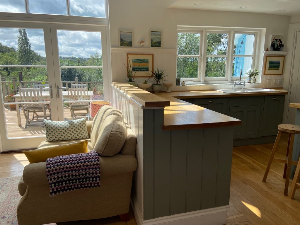 a view of a living room filled with furniture and a large window