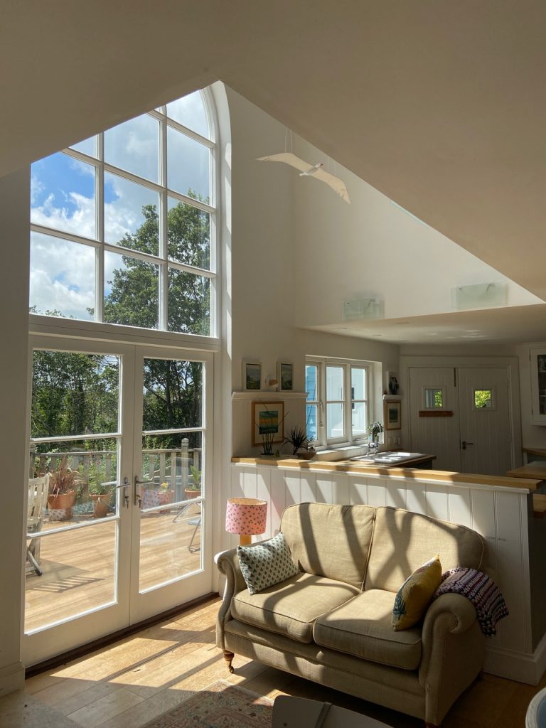 a living room filled with furniture and a large window