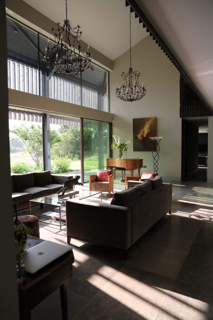 a view of a living room filled with furniture and a large window