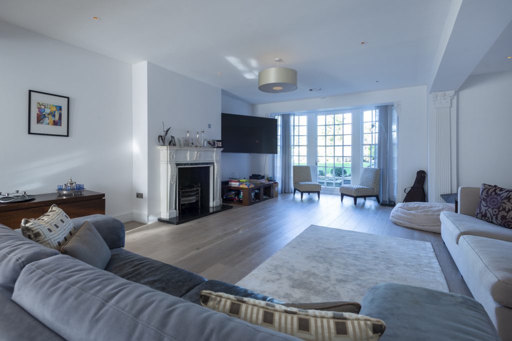 a living room filled with furniture and a large window