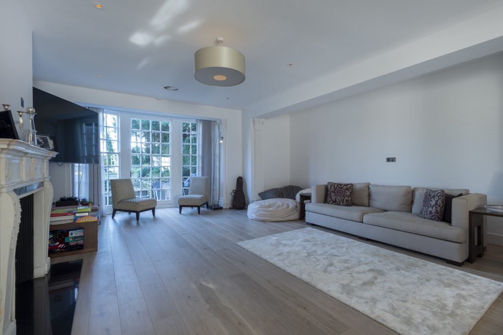 a living room filled with furniture and a large window