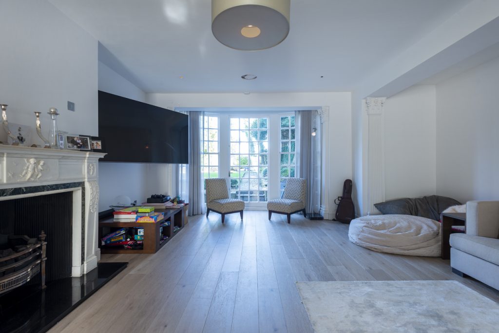 a living room filled with furniture and a flat screen tv
