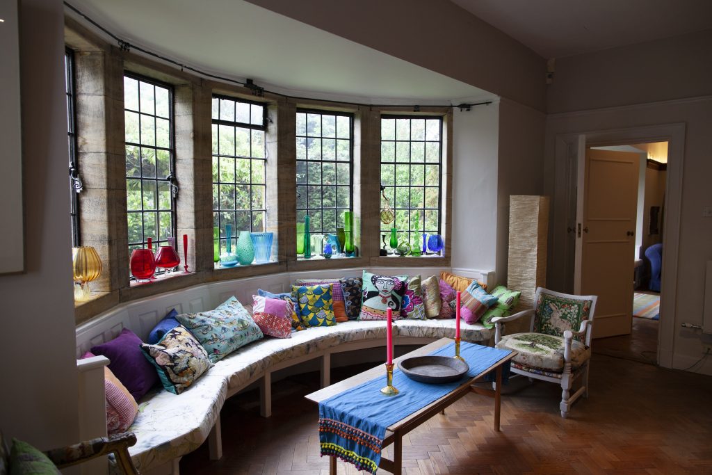 a living room filled with furniture and a large window