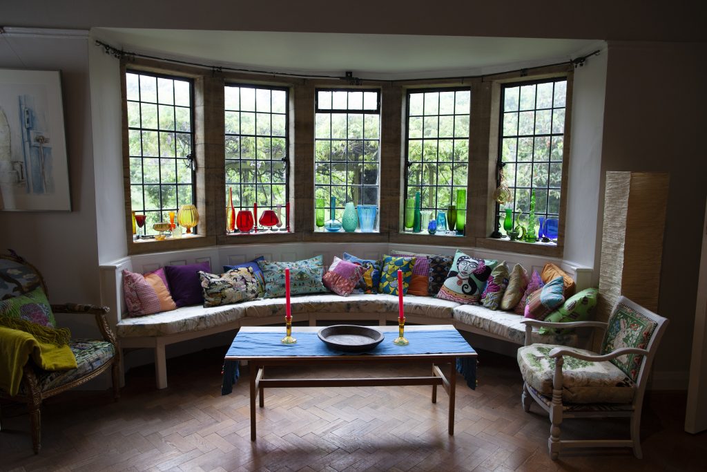 a living room filled with furniture and a large window