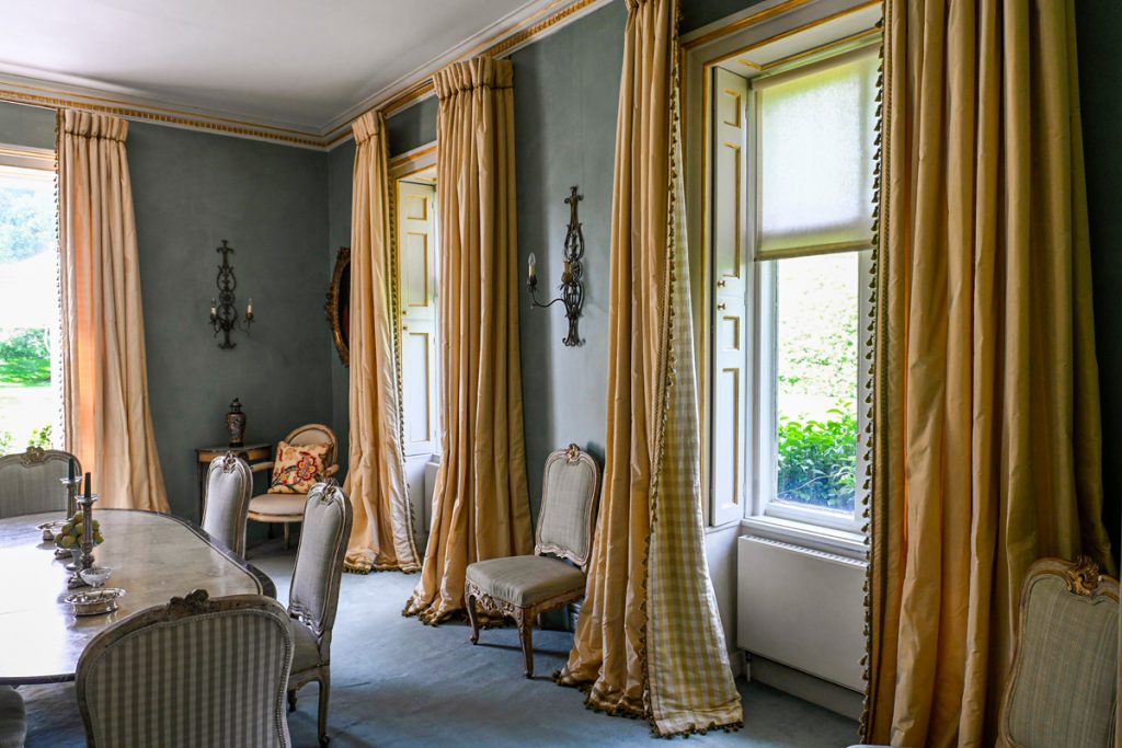 a hotel room filled with furniture and a large window