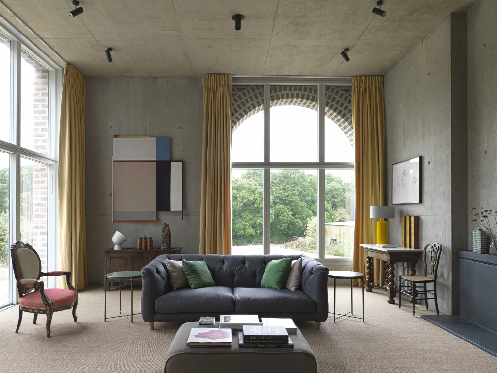 a living room filled with furniture and a large window