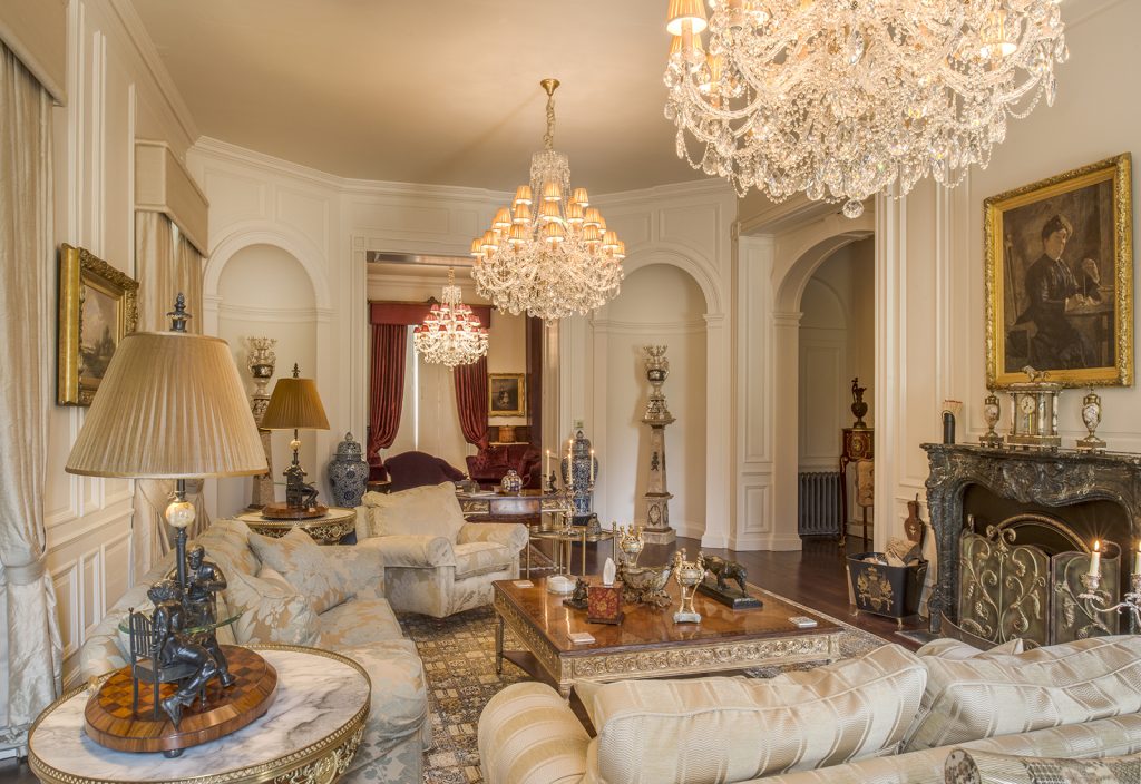 a room filled with furniture and vase of flowers on a table