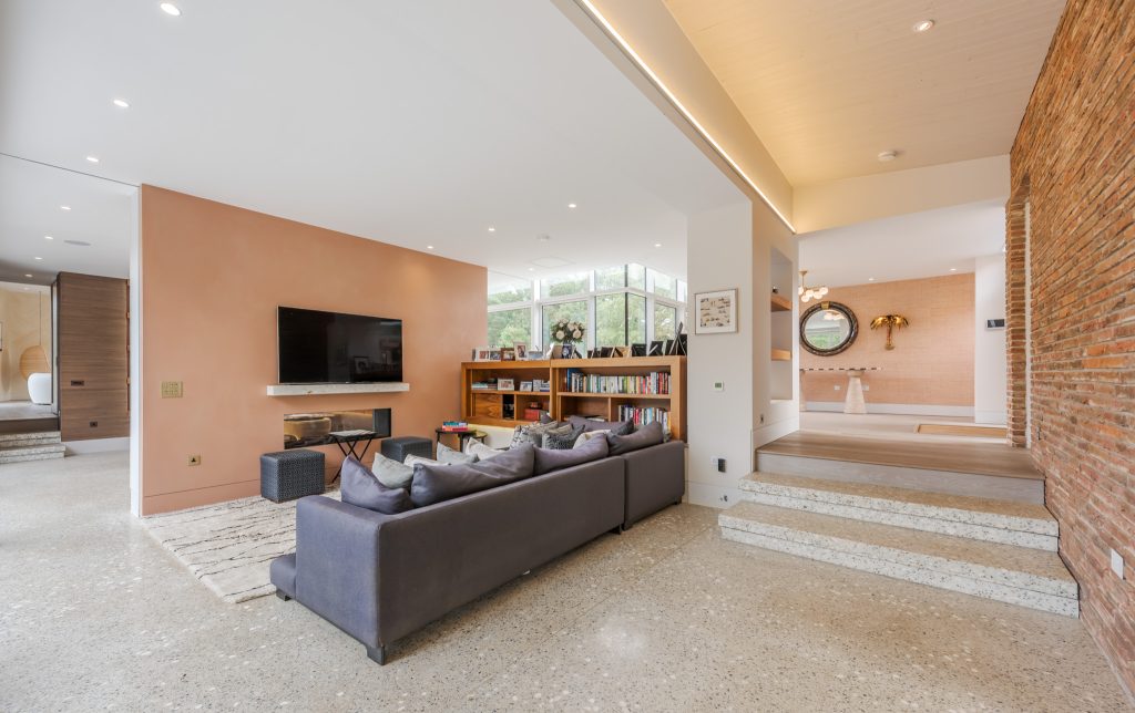 a living room filled with furniture and a large window