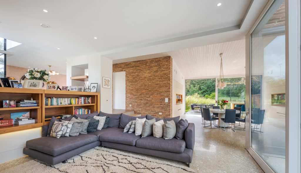 a living room filled with furniture and a large window