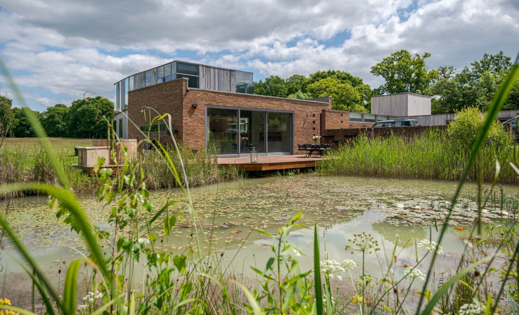 a building with a pond in a garden