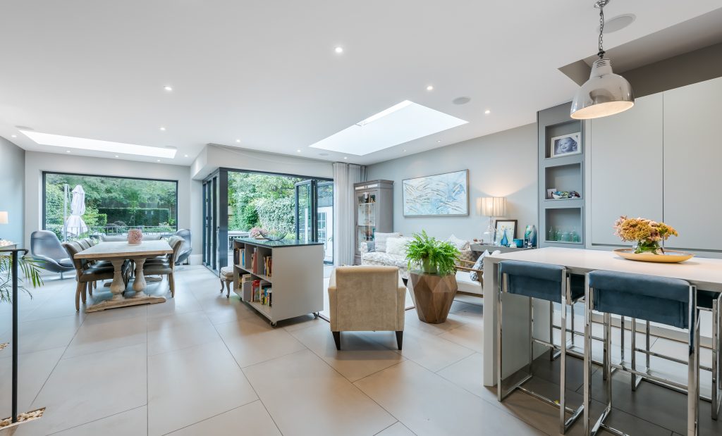 a living room filled with furniture and a large window