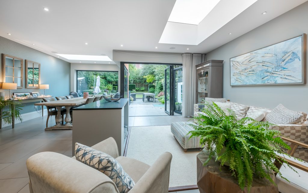 a living room filled with furniture and a large window