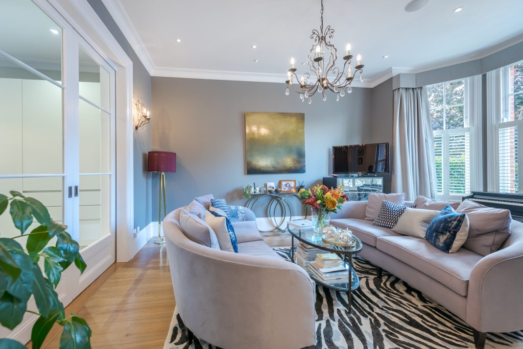a living room filled with furniture and a large window
