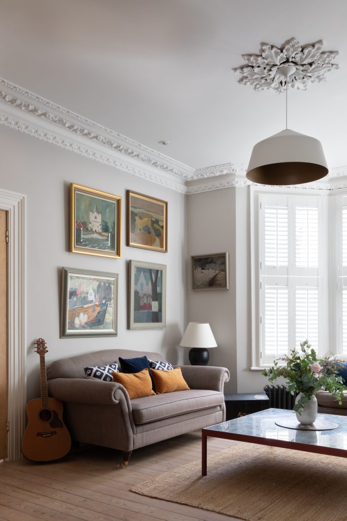 a living room filled with furniture and a large window