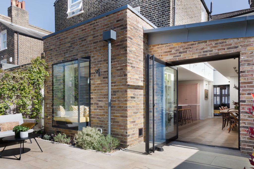 a chair sitting in front of a brick building