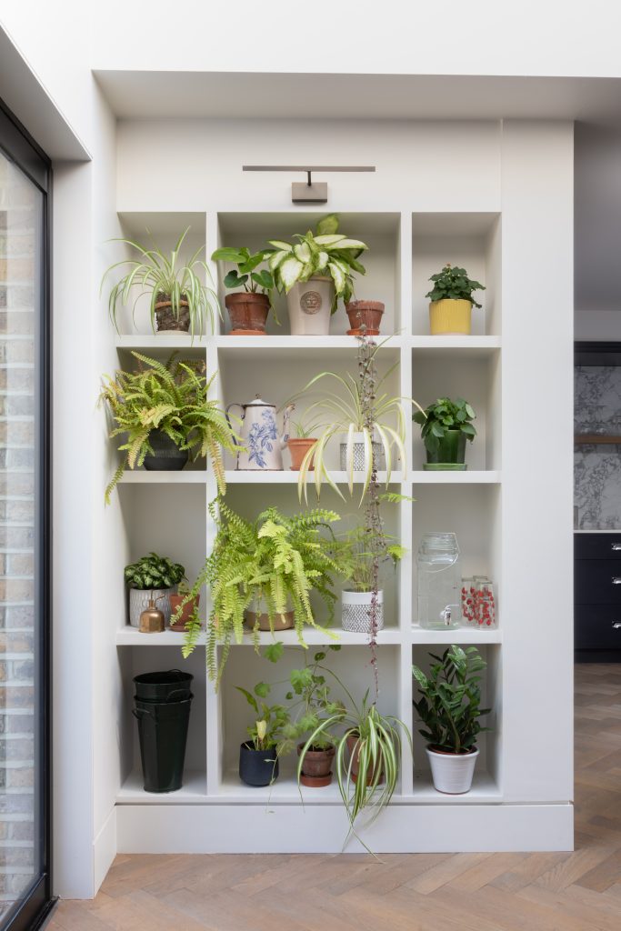 a room filled with furniture and vase of flowers
