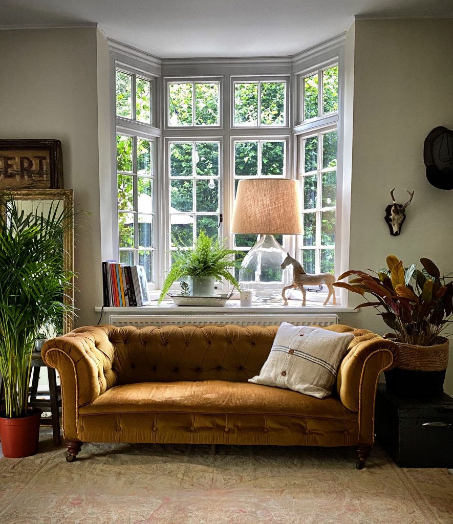 a living room filled with furniture and a large window