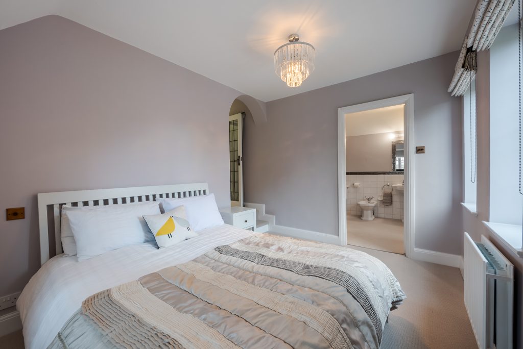 a bedroom with a bed in a room
