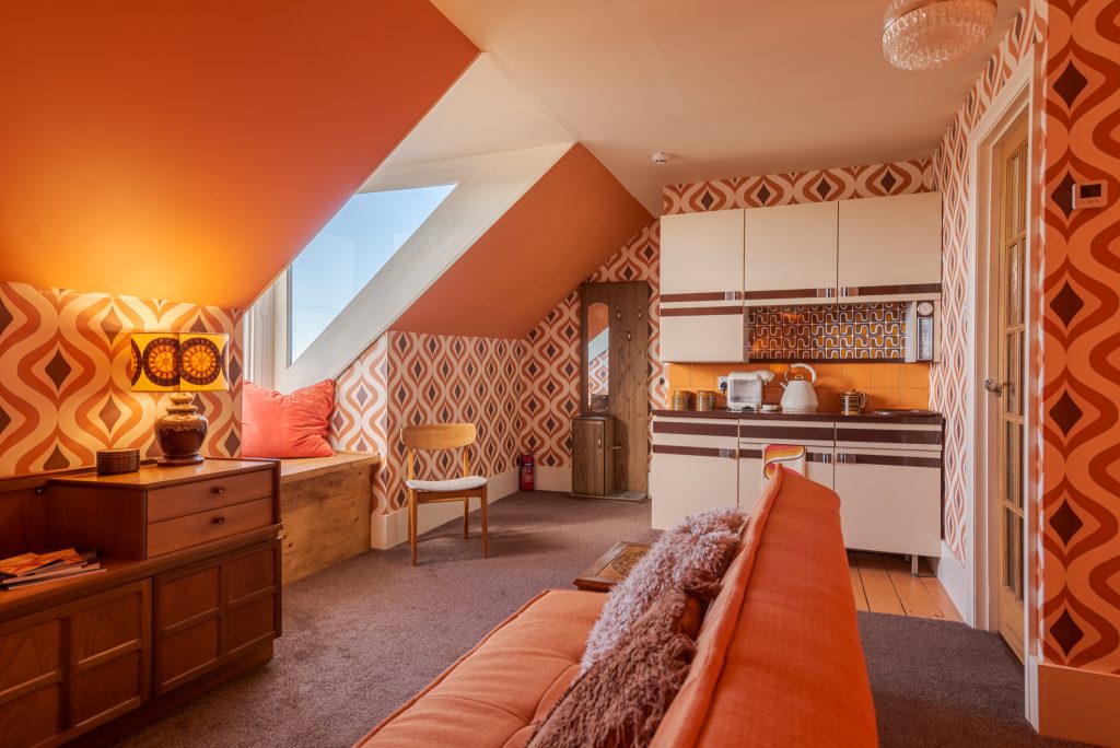 a bedroom with a bed and a chair in a room
