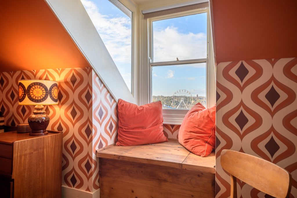 a room filled with furniture and a large window
