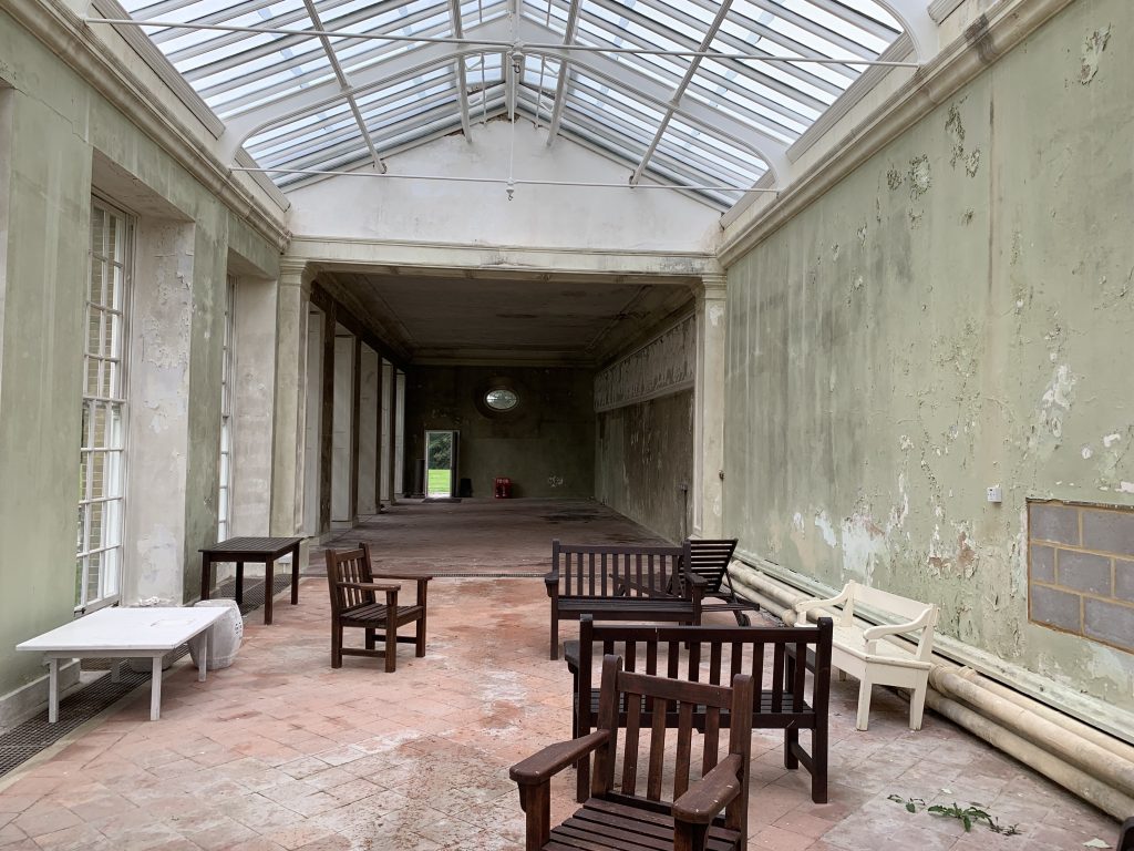 a wooden bench sitting in front of a building