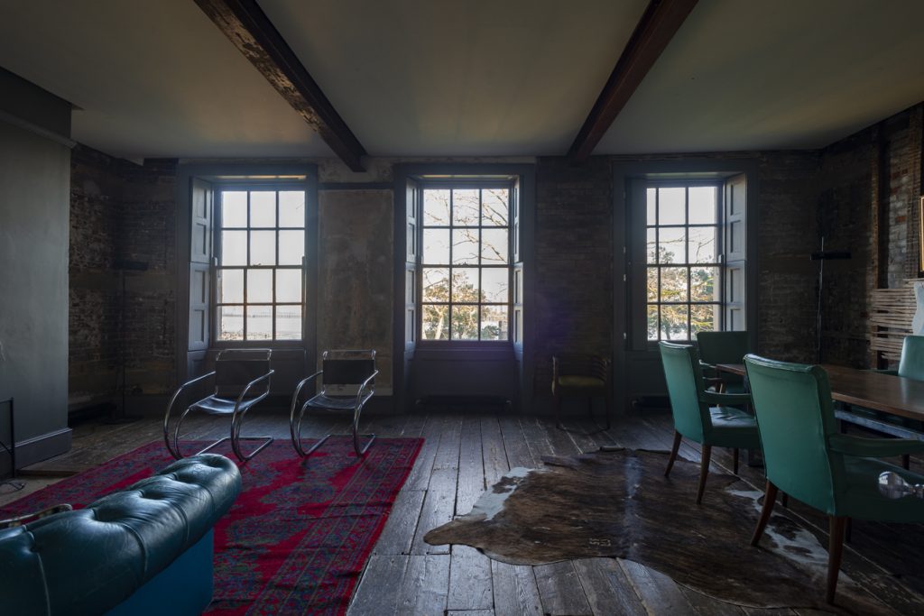 a living room filled with furniture and a large window