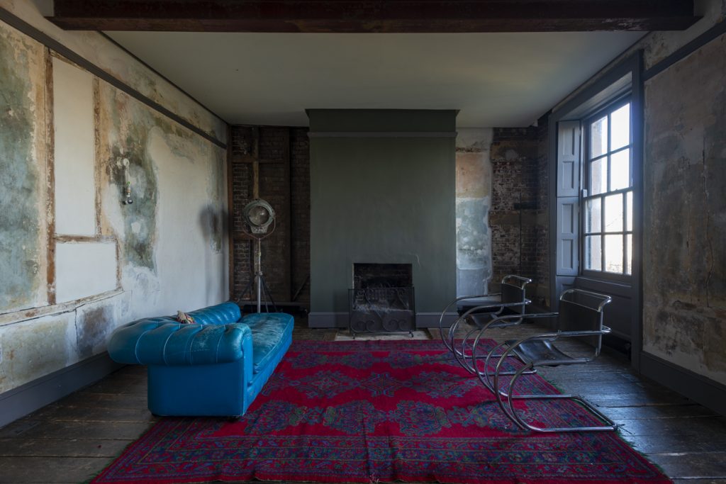 a room filled with furniture and a large window