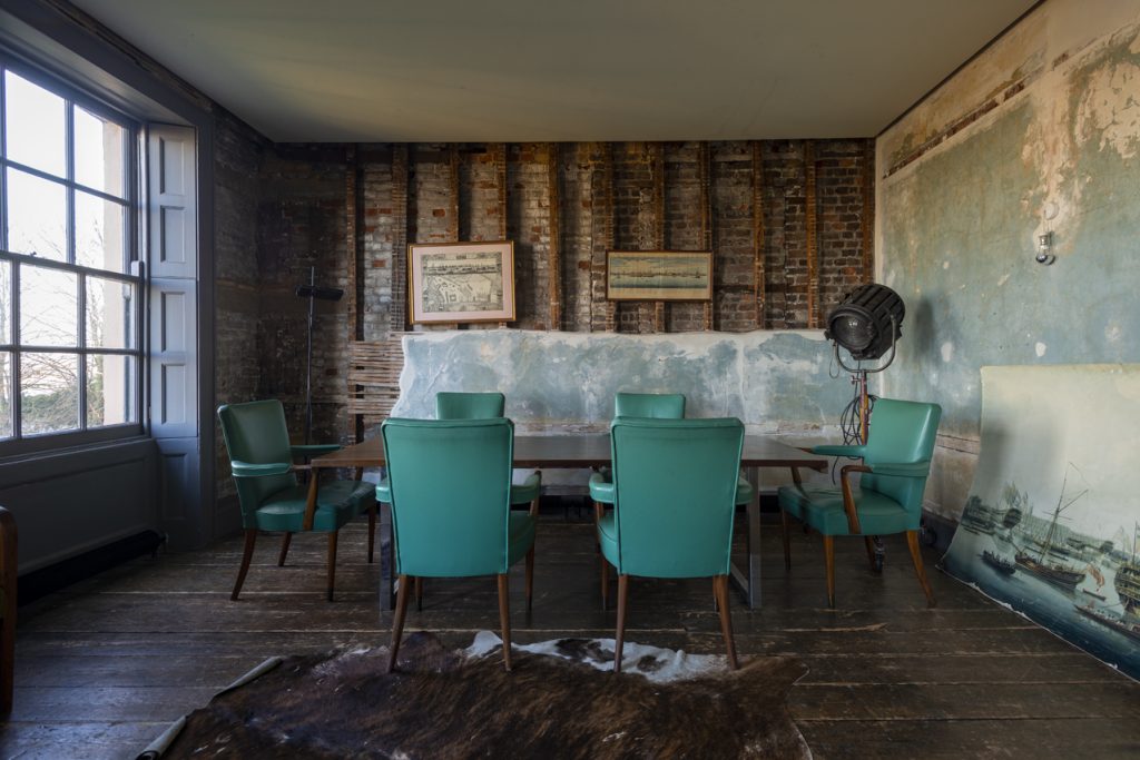 a living room filled with furniture and a large window