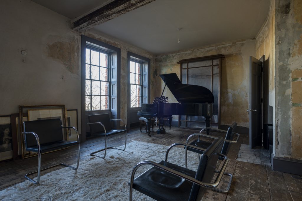 a room filled with furniture and a large window