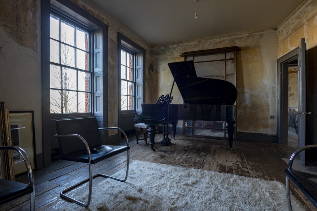 a living room filled with furniture and a large window