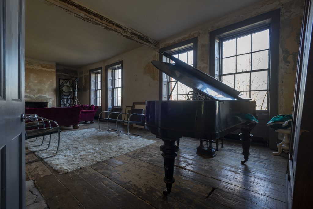a room filled with furniture and a large window