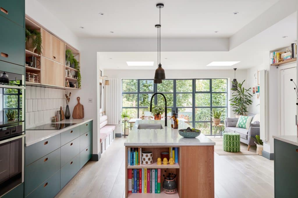 a living room filled with furniture and a window in a kitchen