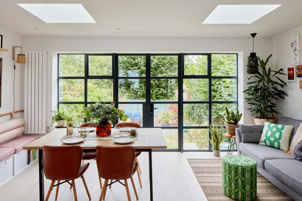 a living room filled with furniture and a large window