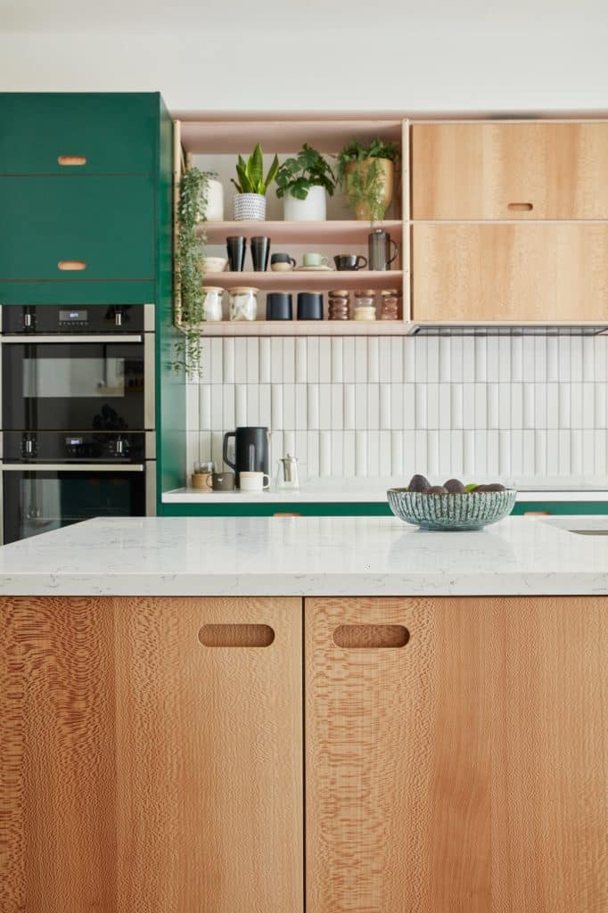 a kitchen with green walls