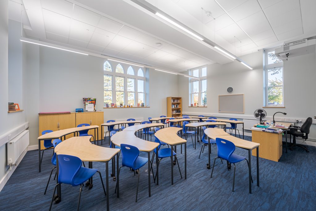 an office with a desk and chair in a room
