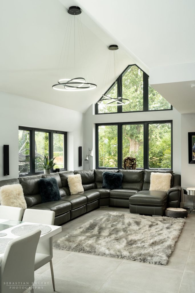 a view of a living room filled with furniture and a large window