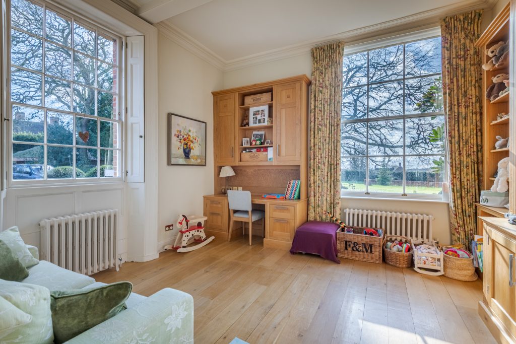 a view of a living room filled with furniture and a large window