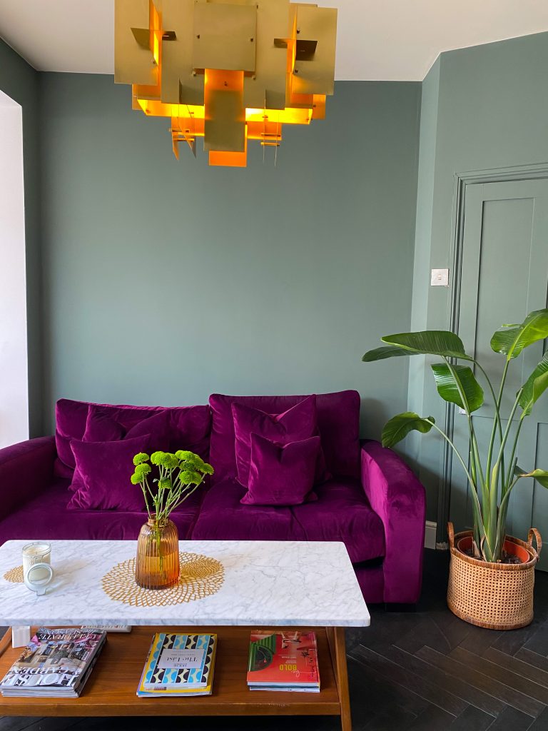 a living room filled with furniture and vase of flowers on a table