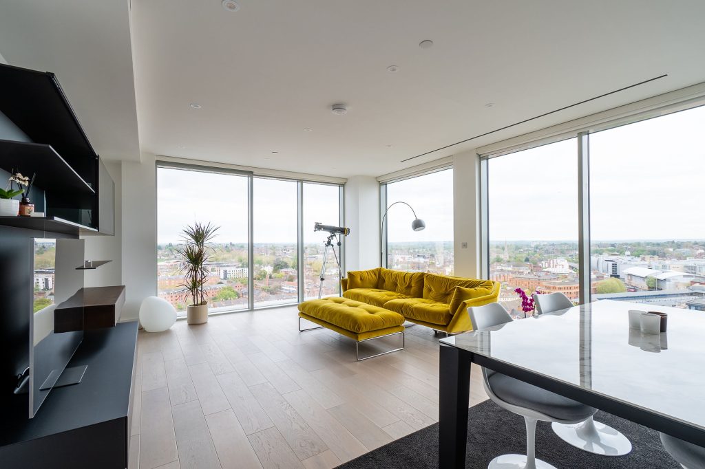 a living room filled with furniture and a large window